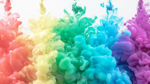 Red, yellow, green, blue, and purple drops of colors, swirling as  they dissolve in water. Photo taken by Pawel Czerwinski.

